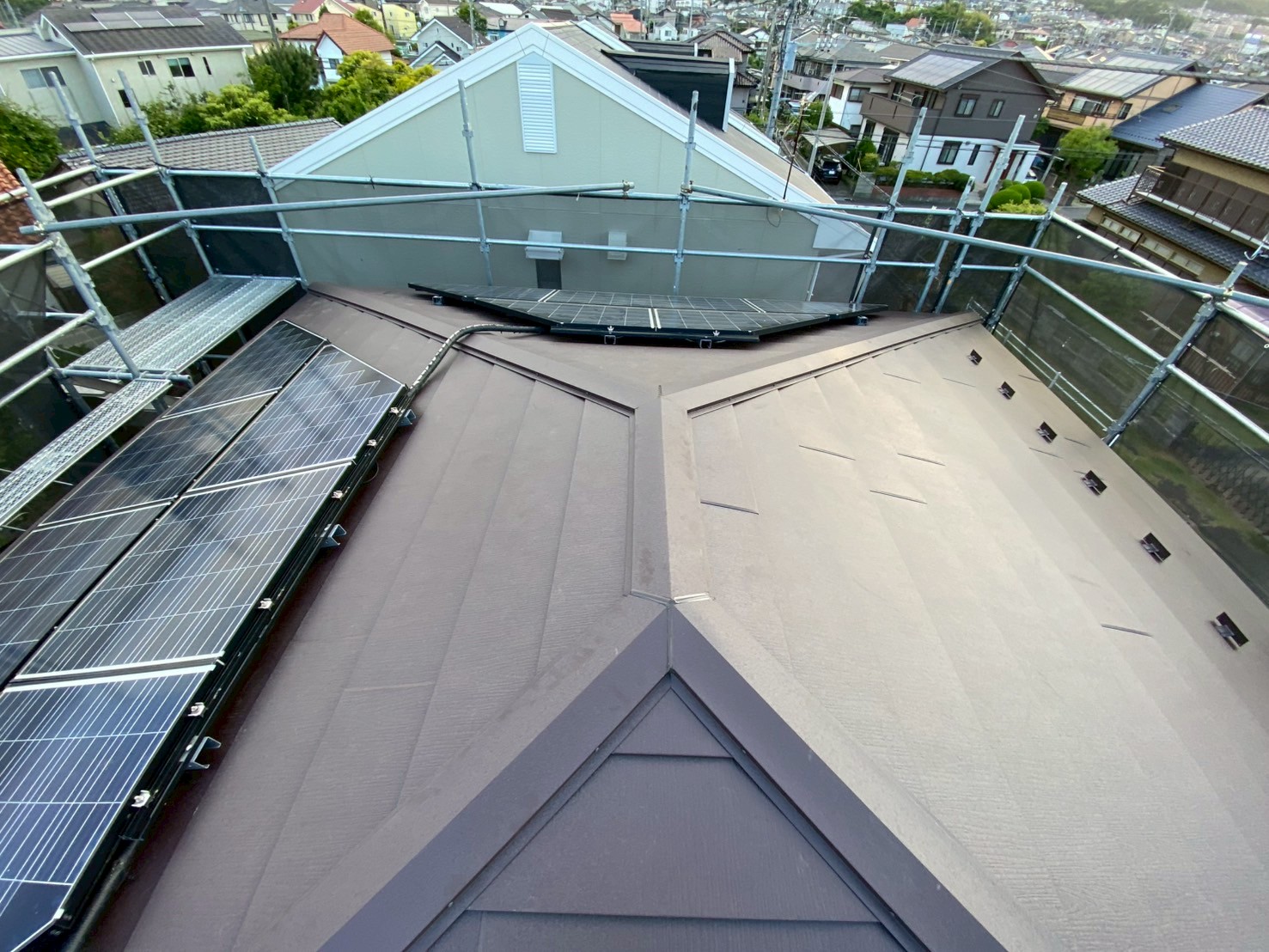 さいたま市北区にて太陽光パネル付き赤いスレート屋根にスーパーガルテクトを使った屋根カバー工事♪